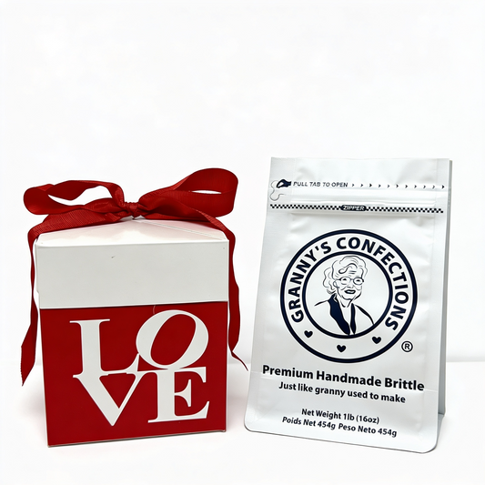 White gift box with red ribbon and 'LOVE' text, next to a bag of Granny's Confections brittle.